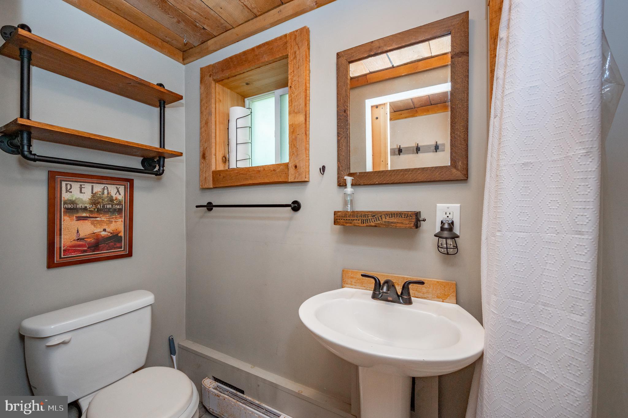 560 Glendale Road Oakland, MD 21550 - Photo 9 of 24 a bathroom with a toilet sink and mirror
