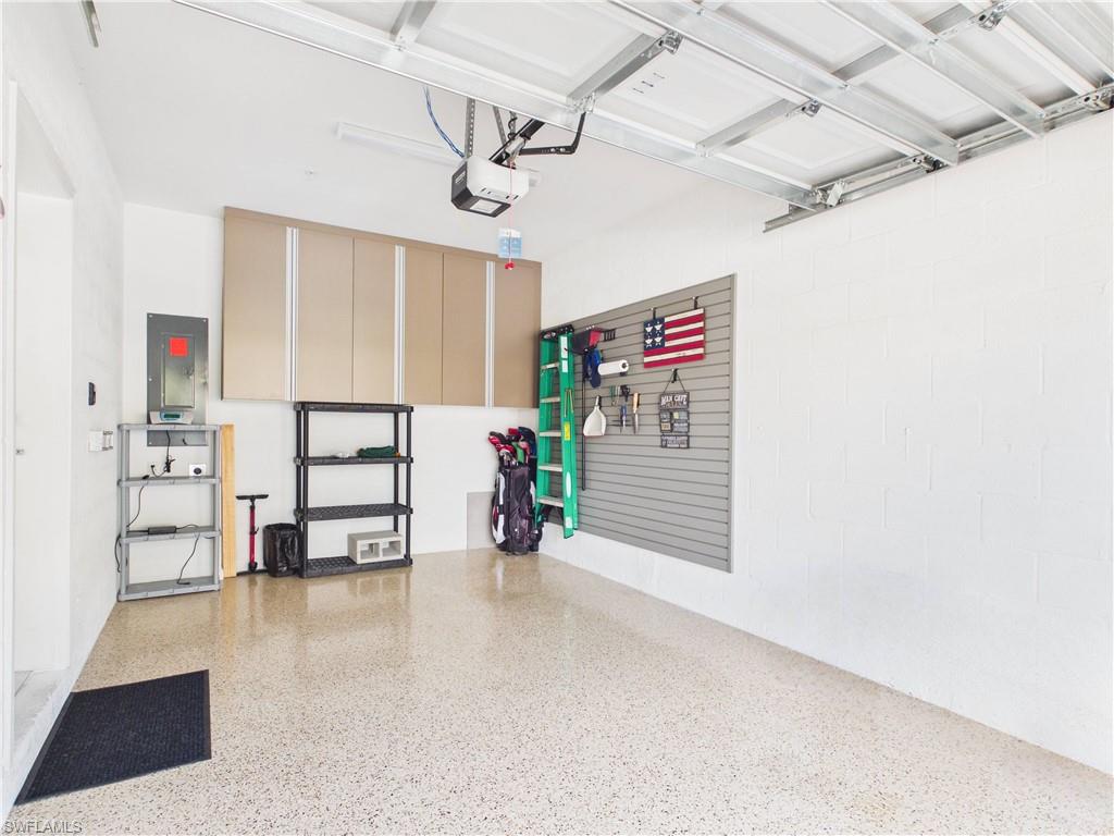 5683 Mayflower Way, Unit 908 Ave Maria, FL 34142 - Photo 33 of 37 Garage with electric panel and a garage door opener