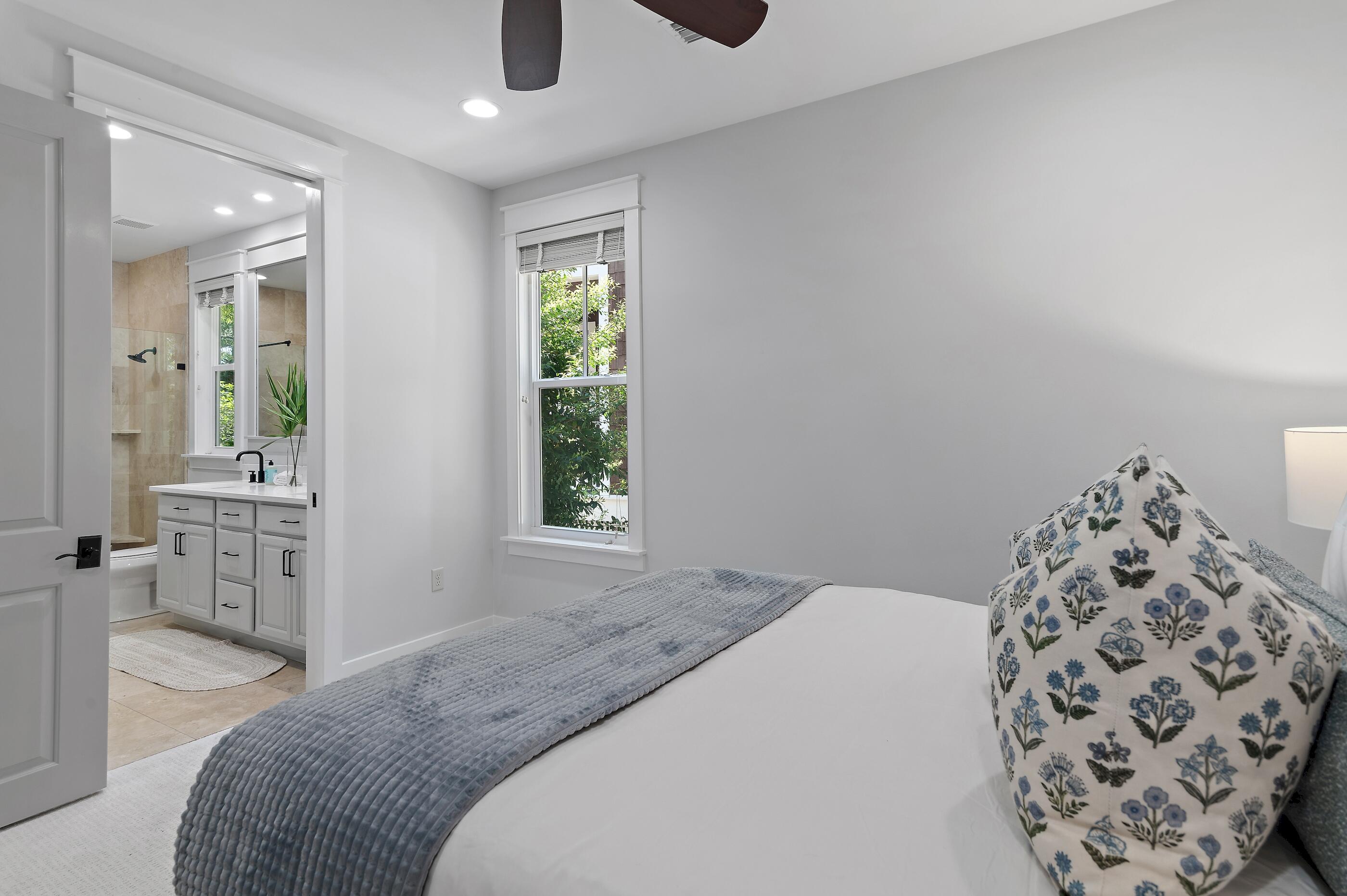 199 Anchor Rode Circle Santa Rosa Beach, FL 32459 - Photo 14 of 43 a bedroom with a large bed and a chandelier