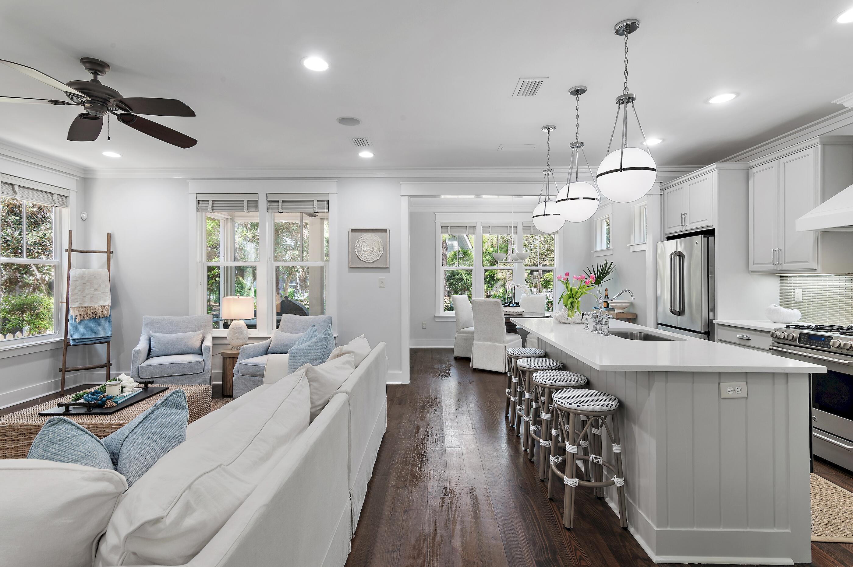 199 Anchor Rode Circle Santa Rosa Beach, FL 32459 - Photo 5 of 43 a view of a kitchen and dining room with wooden floor a chandelier