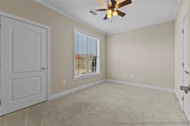 a view an empty room with wooden floor and fireplace