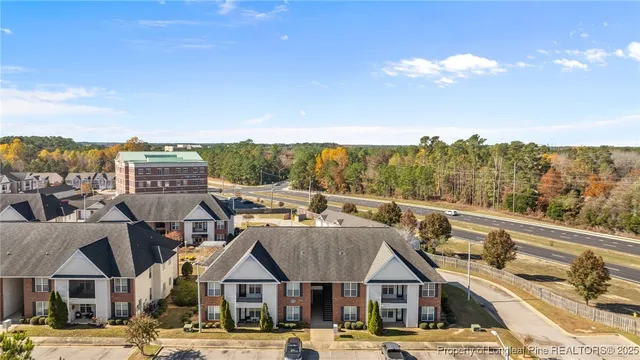 a view of a big house with a big yard and large trees