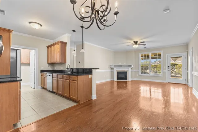 a kitchen with granite countertop a sink and stainless steel appliances