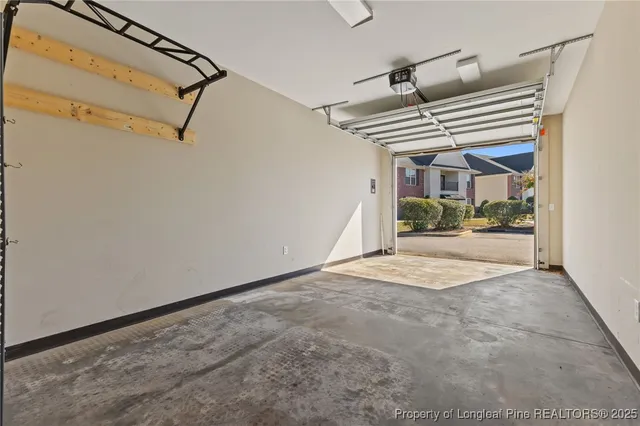 a view of a patio with a table and chairs and a barbeque