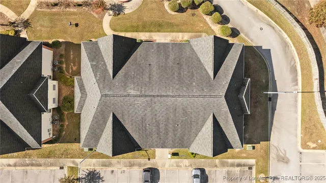 an aerial view of a house with a yard