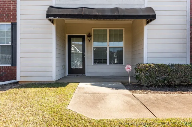 a view of a brick house with a yard