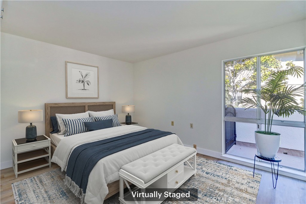 2123 Ronda Granada, Unit A Laguna Woods, CA 92637 - Photo 21 of 34 a bedroom with a large bed and a potted plant