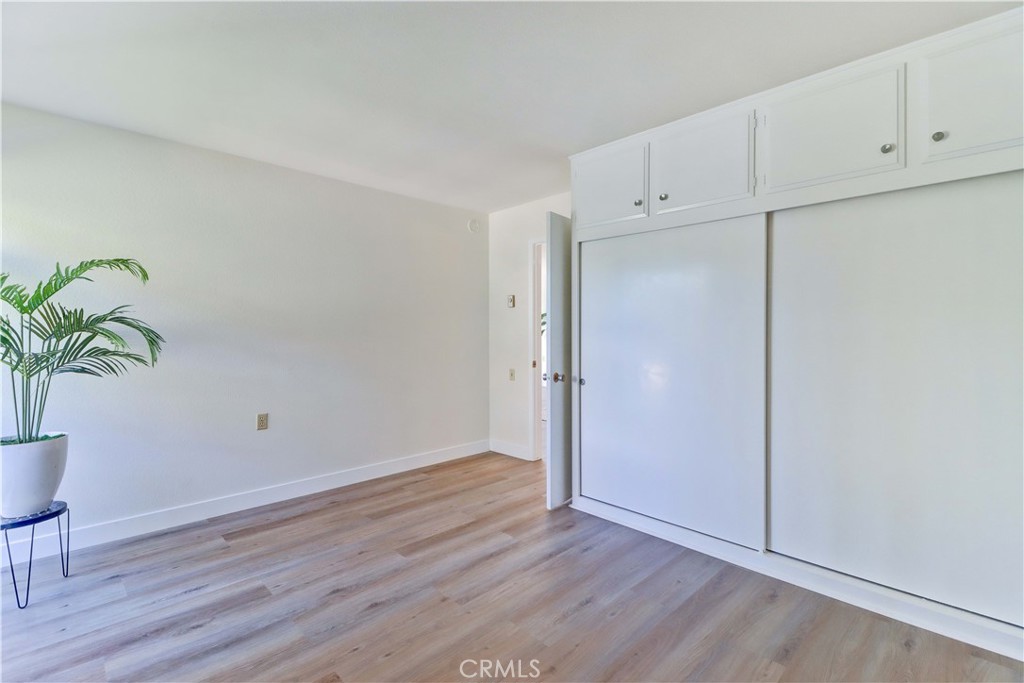 2123 Ronda Granada, Unit A Laguna Woods, CA 92637 - Photo 23 of 34 a view of an empty room with wooden floor