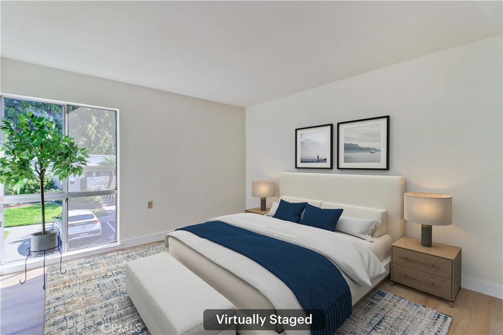 2123 Ronda Granada, Unit A Laguna Woods, CA 92637 - Photo 26 of 34 a bedroom with a bed and a potted plant