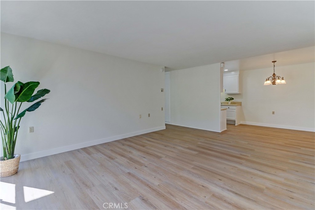 2123 Ronda Granada, Unit A Laguna Woods, CA 92637 - Photo 8 of 34 a view of empty room with wooden floor and potted plant