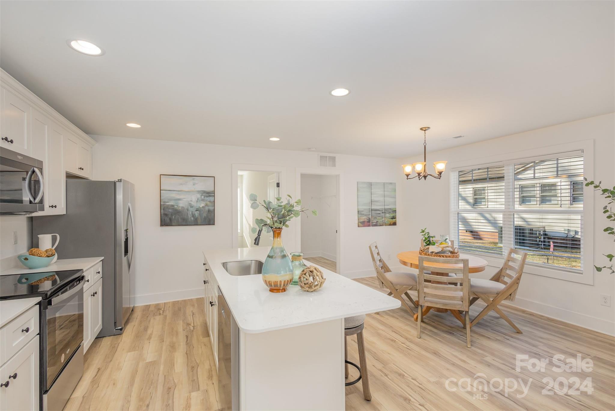 2832 South Ridge Avenue Concord, NC 28025 - Photo 6 of 18 a living room with stainless steel appliances kitchen island granite countertop furniture and a kitchen view