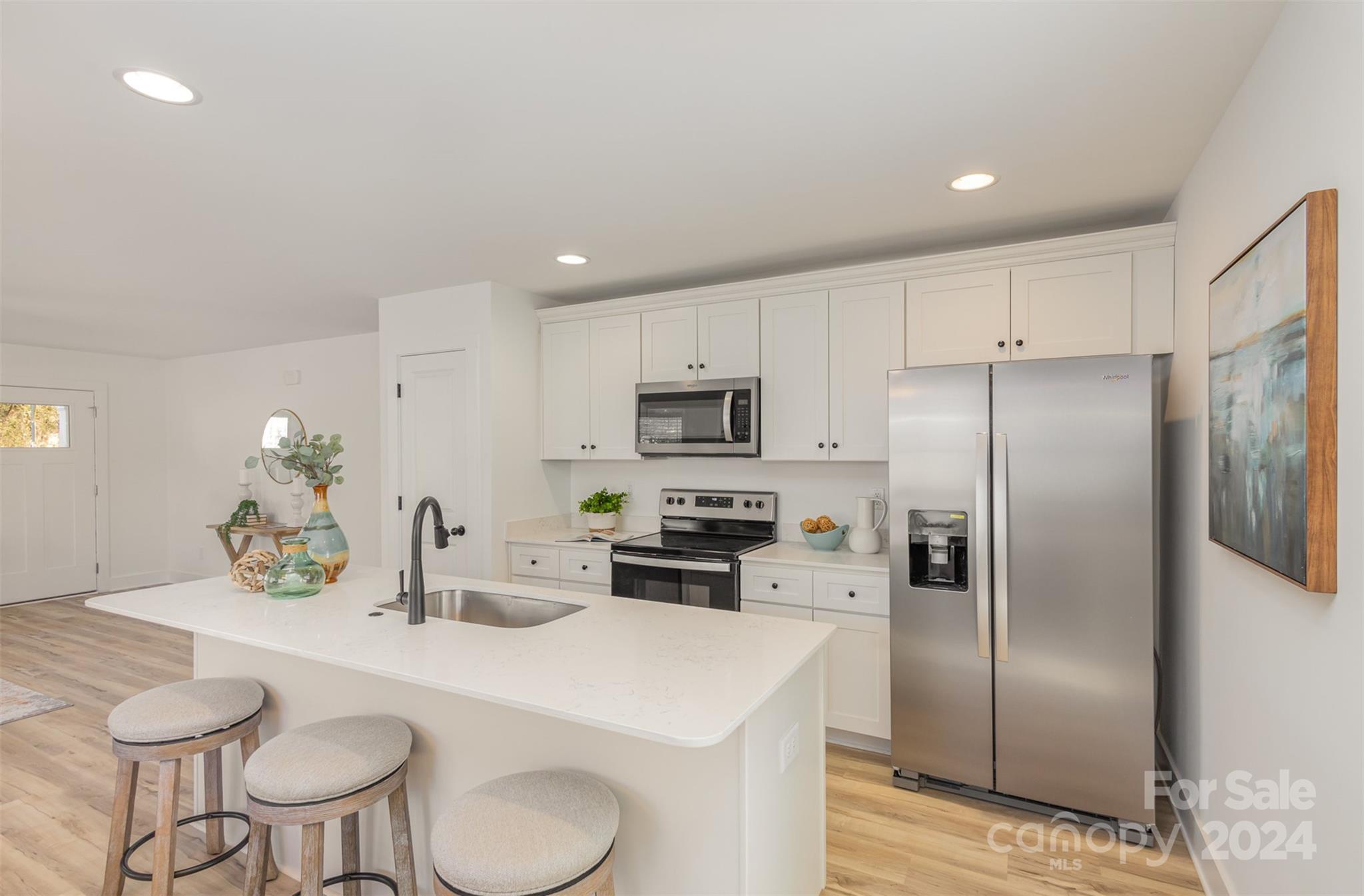 2832 South Ridge Avenue Concord, NC 28025 - Photo 8 of 18 a kitchen with stainless steel appliances a refrigerator a sink a stove a table and chairs
