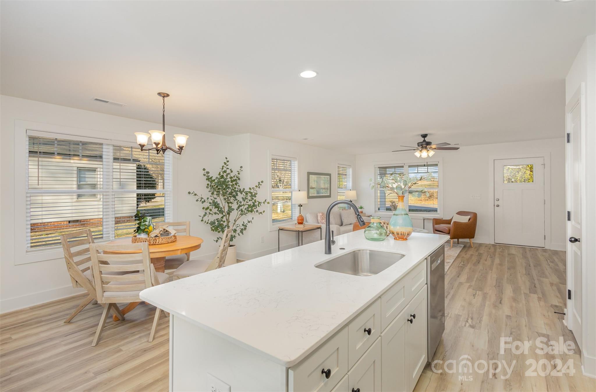 2832 South Ridge Avenue Concord, NC 28025 - Photo 9 of 18 a view of a kitchen area with stainless steel appliances wooden floor dining table and chairs