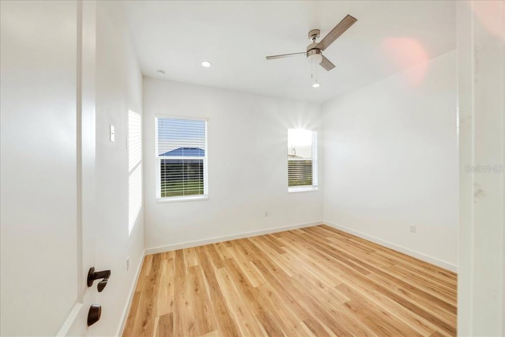 1215 Rio De Janeiro Avenue Punta Gorda, FL 33983 - Photo 13 of 65 an empty room with a window and ceiling fan