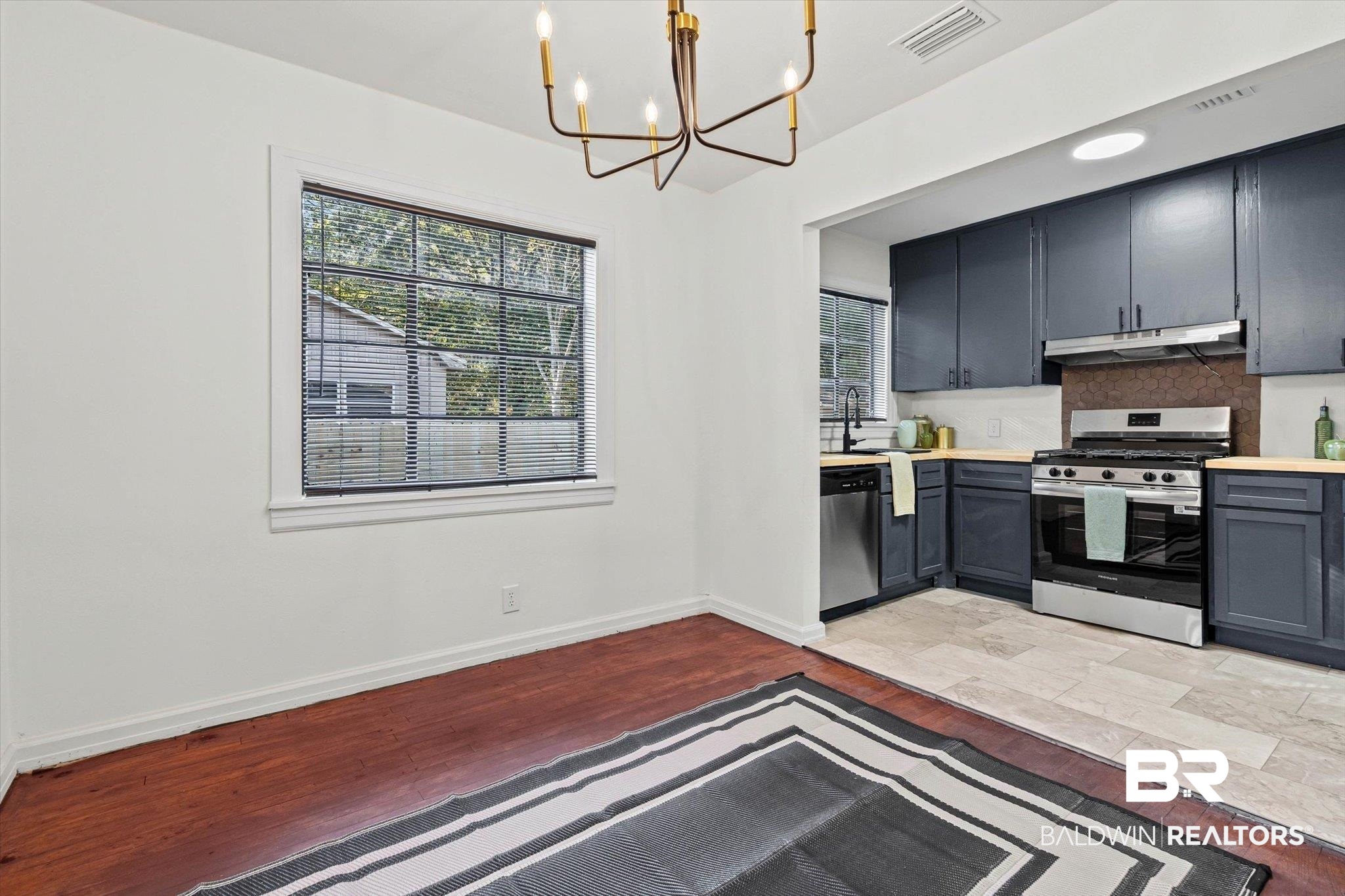 2806 Exter Drive Mobile, AL 36606 - Photo 7 of 24 Kitchen featuring light countertops, light wood-style flooring, stainless steel appliances, a chandelier, and gray cabinetry