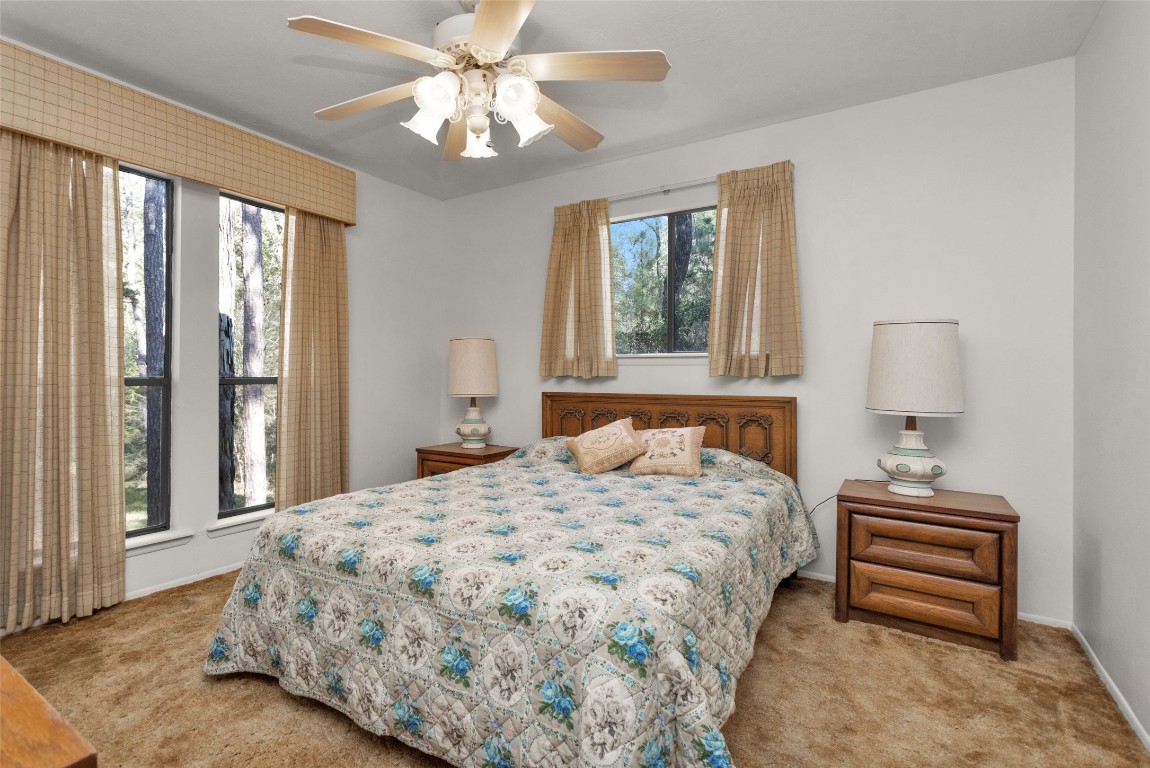 7415 Honea Egypt Road Montgomery, TX 77316 - Photo 31 of 50 a bedroom with a bed dresser and a window