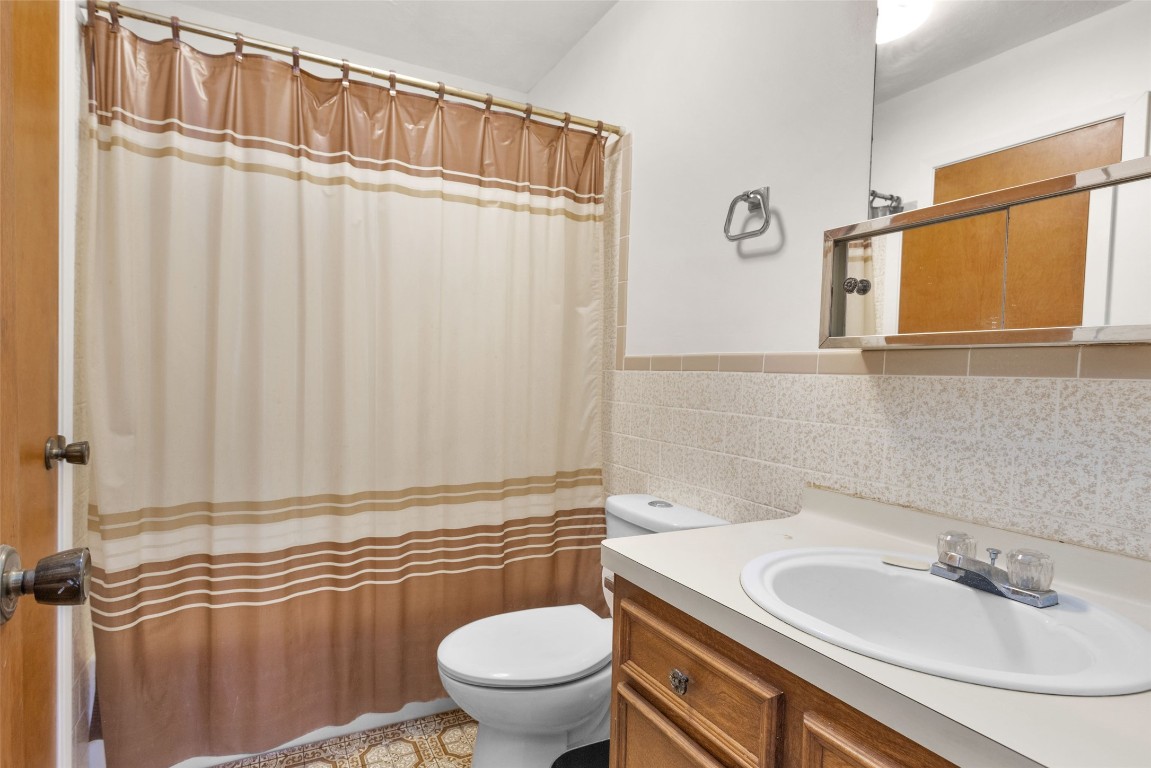 7415 Honea Egypt Road Montgomery, TX 77316 - Photo 33 of 50 a bathroom with a sink a toilet and shower curtain
