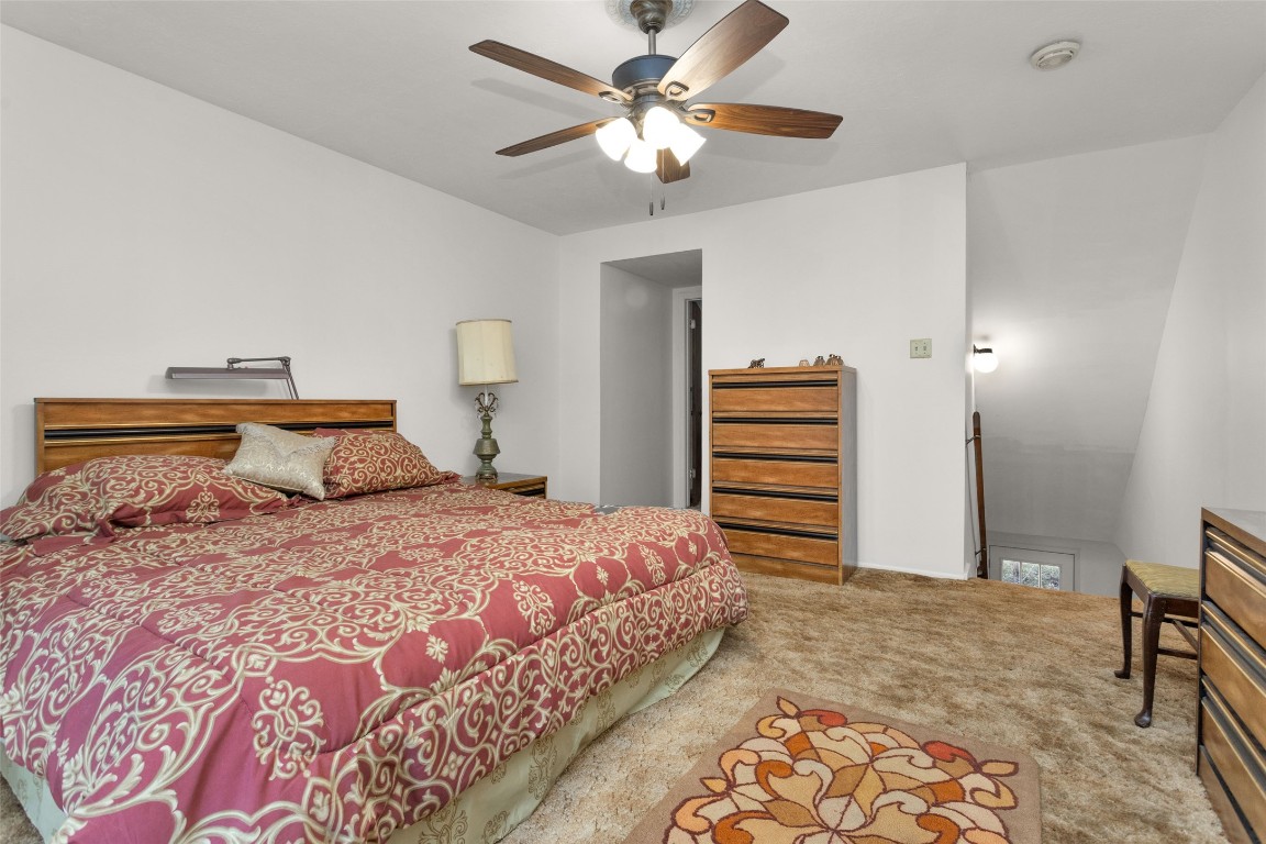 7415 Honea Egypt Road Montgomery, TX 77316 - Photo 38 of 50 a bedroom with a bed and a chandelier