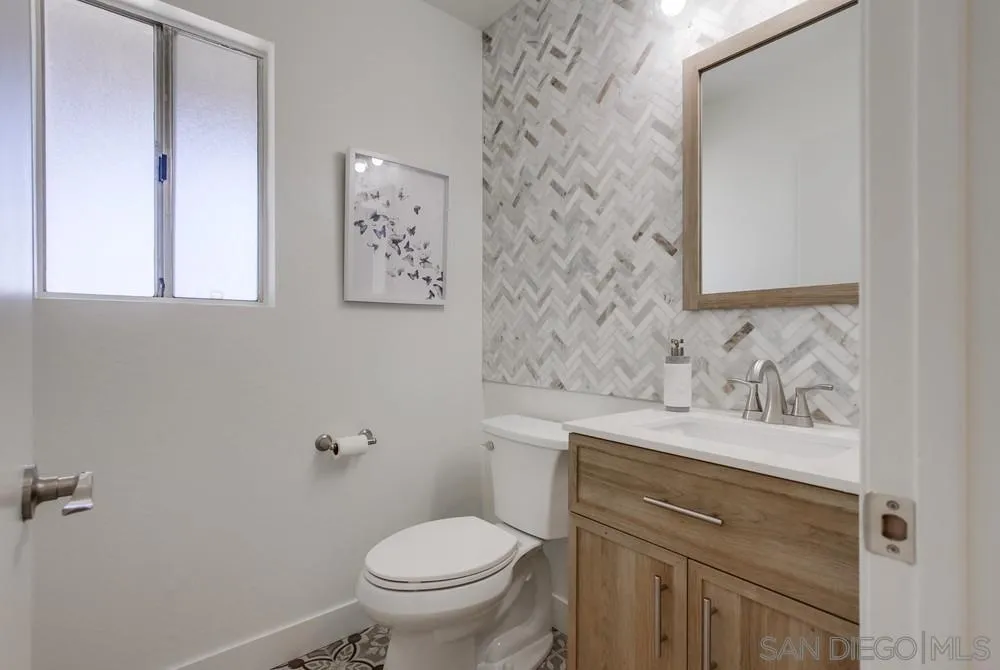 1376 Darwin Drive Oceanside, CA 92056 - Photo 32 of 63 a bathroom with a sink vanity mirror and toilet