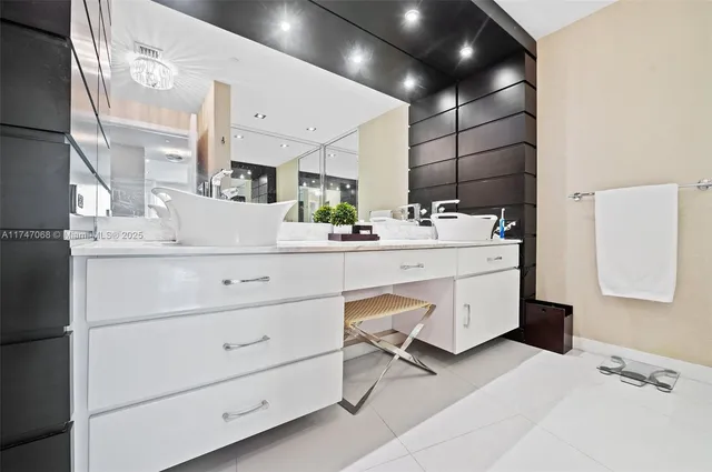a bathroom with a tub sink and mirror