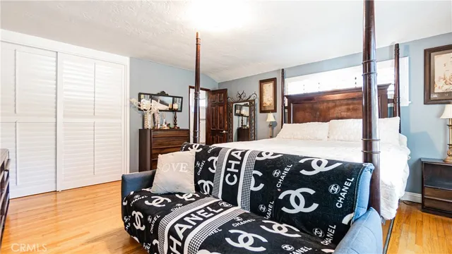 a bedroom with a bed and wooden floor