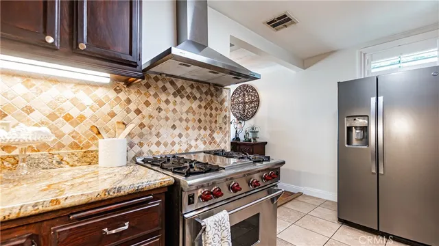 a stove top oven sitting inside of a kitchen