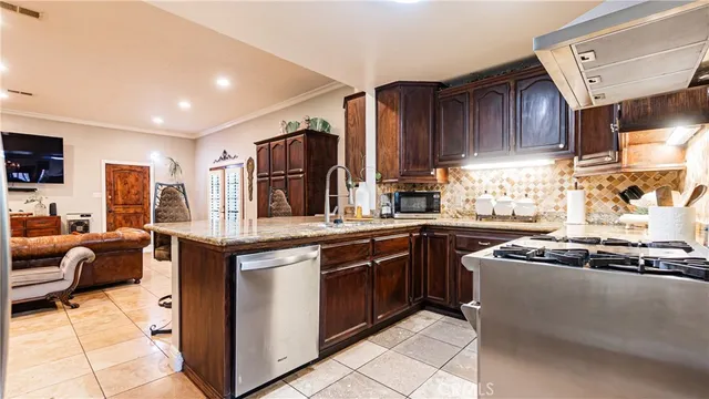 a kitchen with stainless steel appliances granite countertop a sink and cabinets