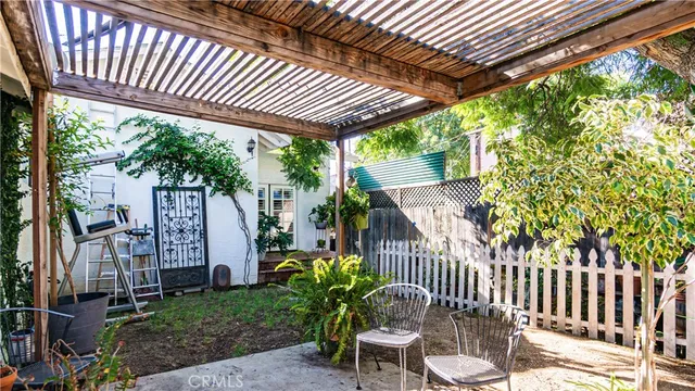 a view of a patio with a table chairs and a backyard