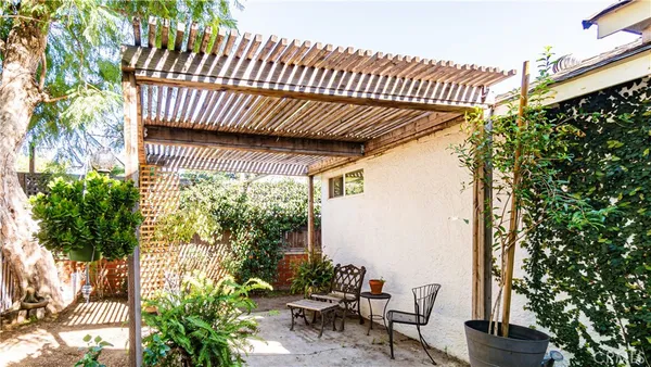 a view of a patio with table and chairs and potted plants