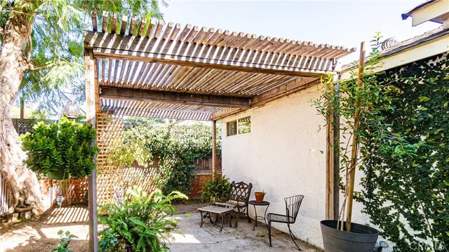 a view of a patio with table and chairs and potted plants