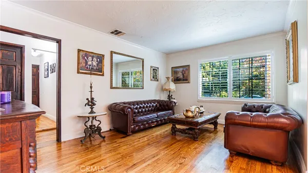 a living room with furniture rug and a window