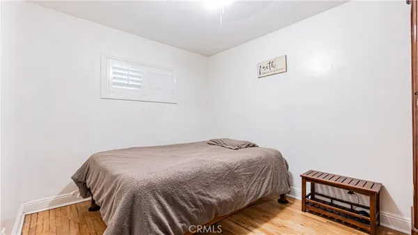 a bedroom with a bed and a desk