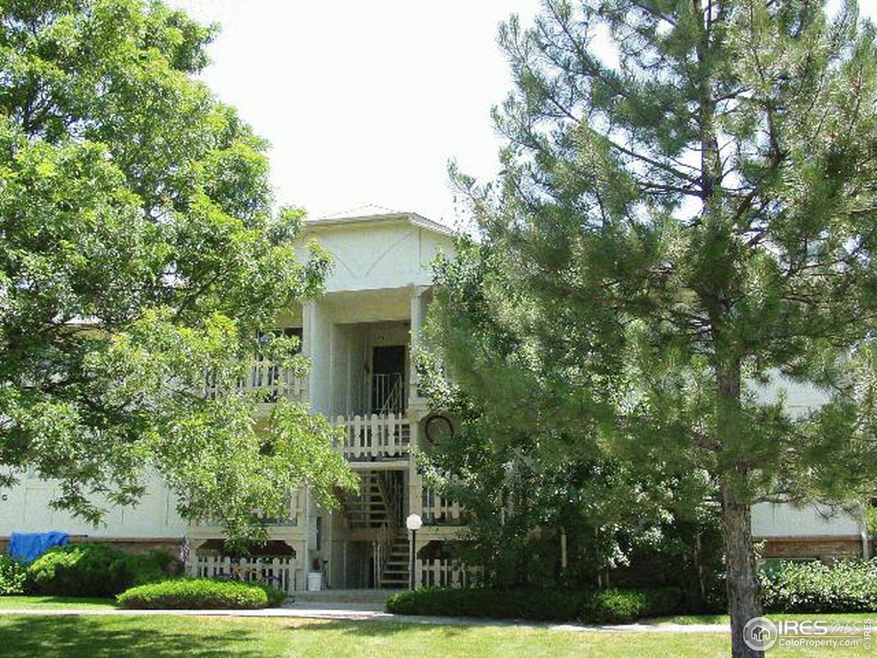 a view of an house with backyard space and balcony