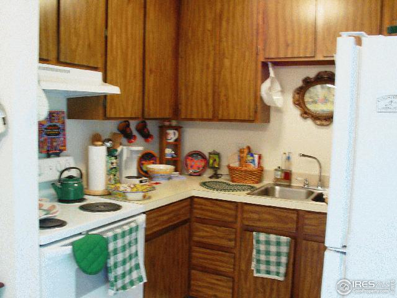 1024 East Swallow Road, Unit 134 Fort Collins, CO 80525 - Photo 2 of 7 a kitchen with stainless steel appliances granite countertop a sink a stove and a refrigerator