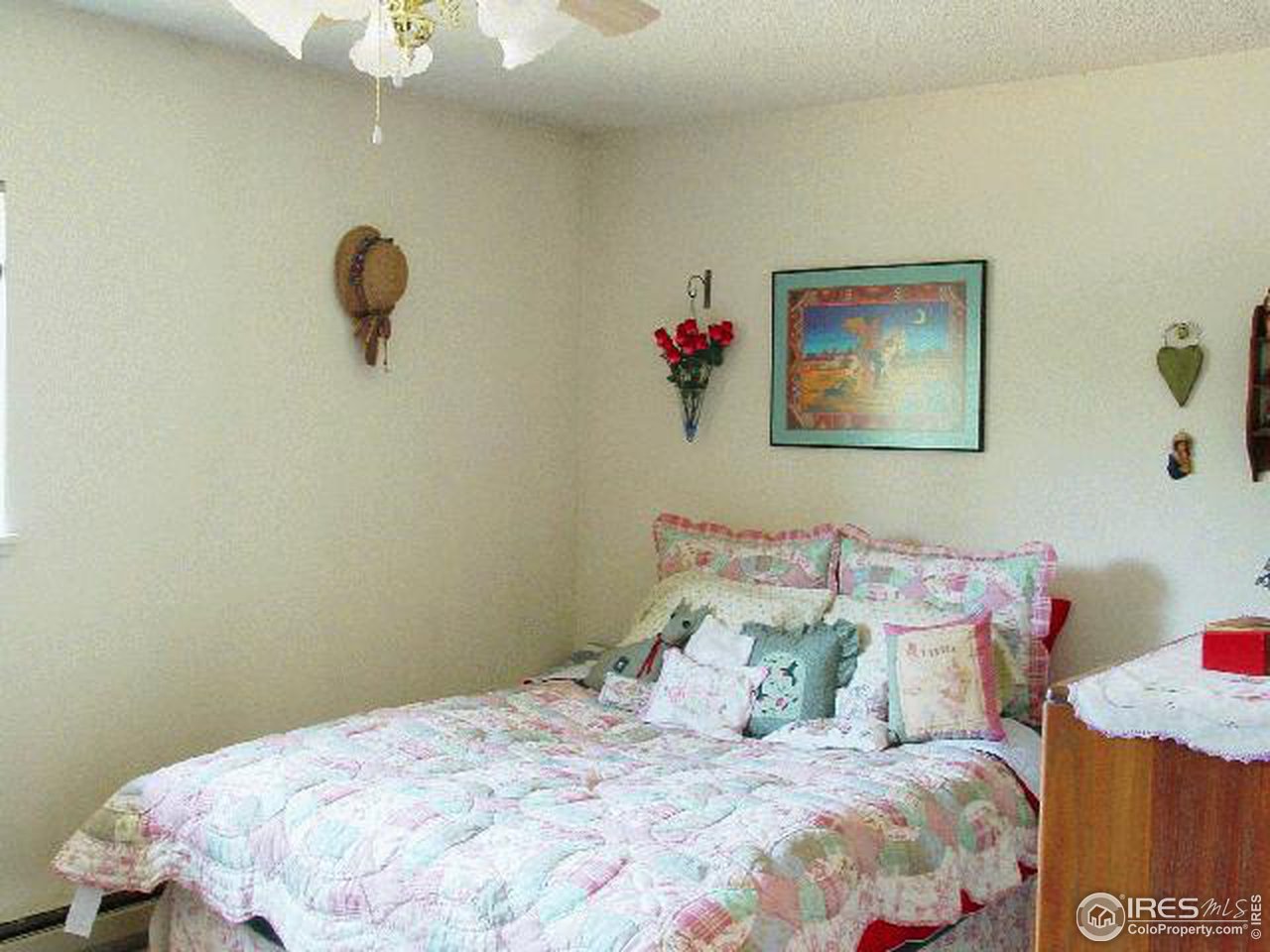 1024 East Swallow Road, Unit 134 Fort Collins, CO 80525 - Photo 5 of 7 a bedroom with a bed and a chandelier