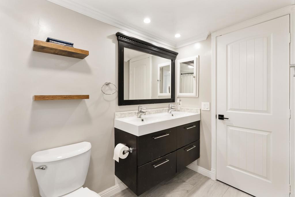 2920 Briarwood Road, Unit G11 Bonita, CA 91902 - Photo 15 of 23 a bathroom with a toilet sink and mirror