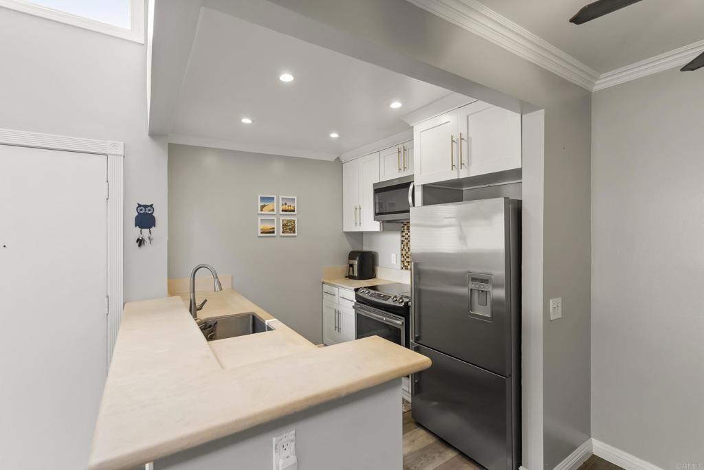 2920 Briarwood Road, Unit G11 Bonita, CA 91902 - Photo 10 of 23 a kitchen with a refrigerator and a sink