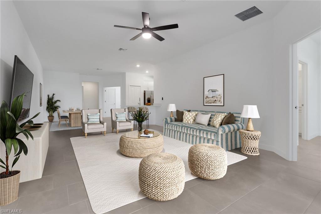 19513 Hinkley Drive Estero, FL 33928 - Photo 11 of 38 a living room with furniture and a flat screen tv