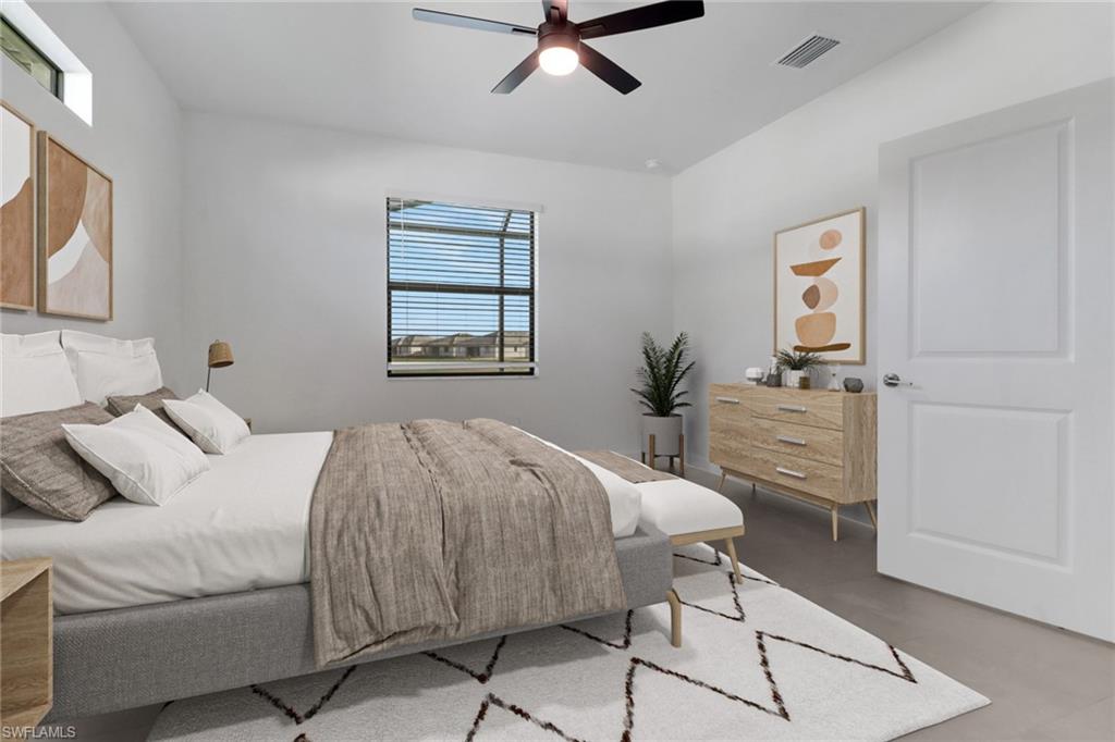 19513 Hinkley Drive Estero, FL 33928 - Photo 13 of 38 a bedroom with a bed and a chandelier