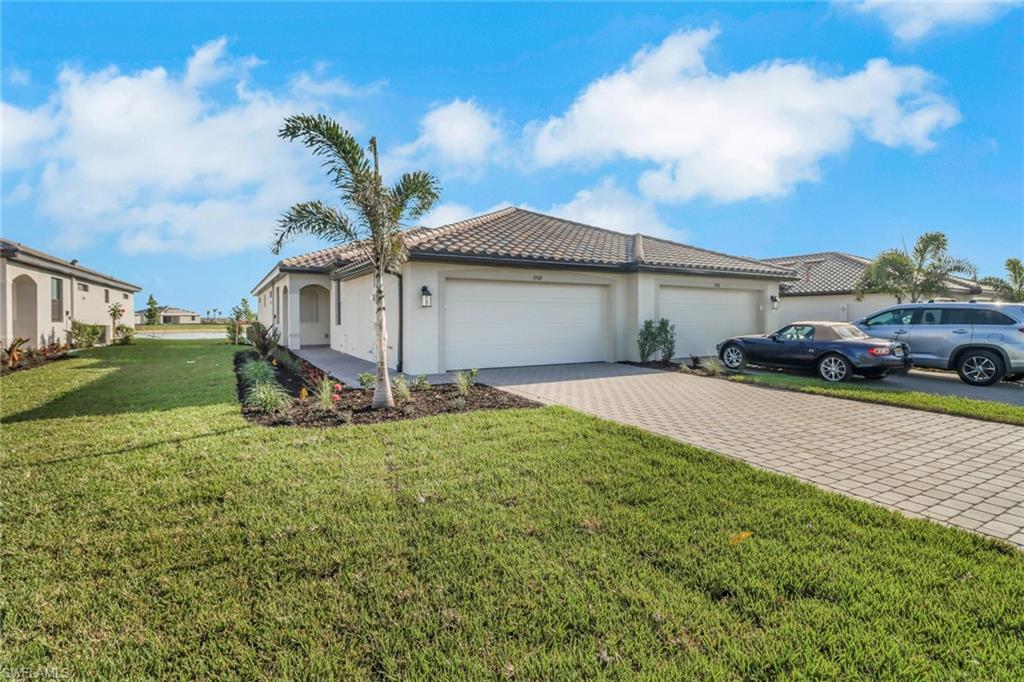 19513 Hinkley Drive Estero, FL 33928 - Photo 2 of 38 a view of a house with a yard