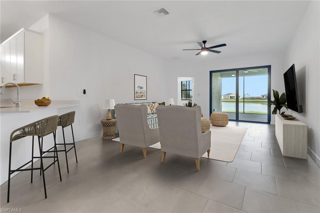 19513 Hinkley Drive Estero, FL 33928 - Photo 9 of 38 a living room with furniture and a flat screen tv