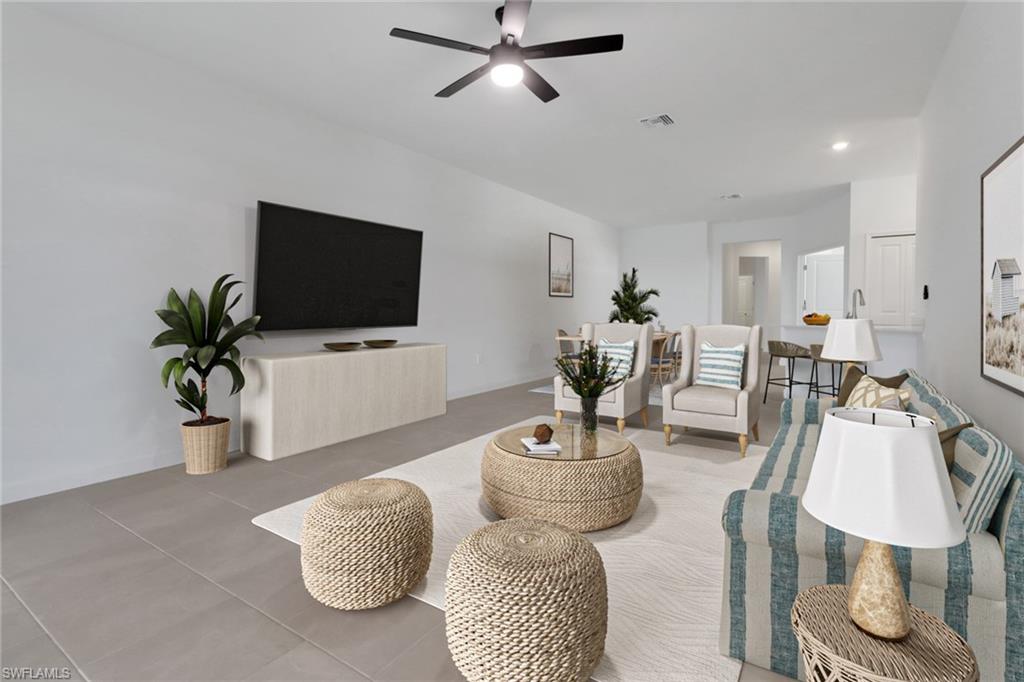 19513 Hinkley Drive Estero, FL 33928 - Photo 10 of 38 a living room with furniture and a flat screen tv