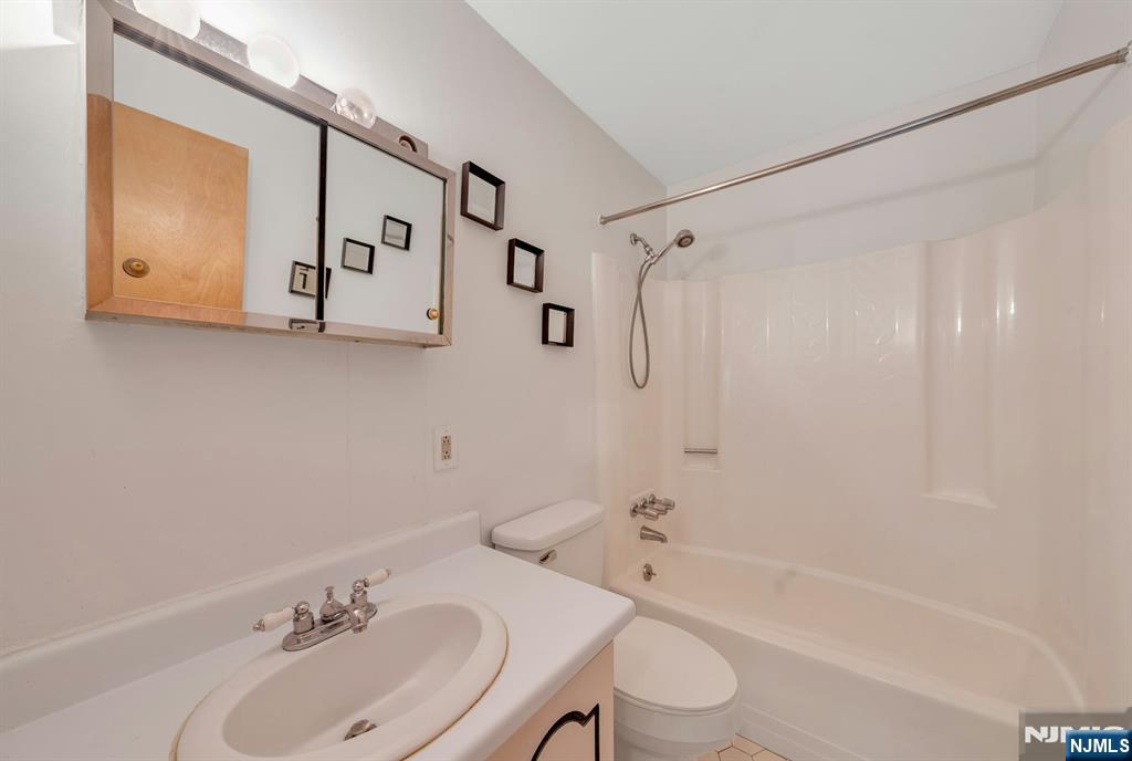 666 Mill Street, Unit C6 Belleville, NJ 07109 - Photo 19 of 25 a bathroom with a sink toilet and shower