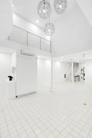 a kitchen with stainless steel appliances kitchen island granite countertop a table chairs sink and cabinets