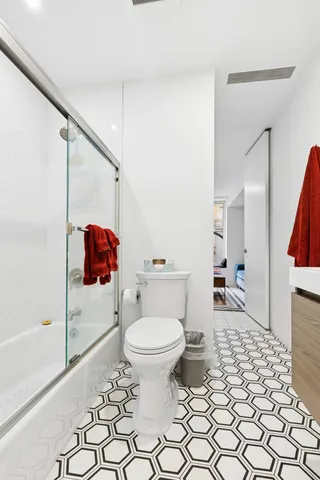 a bathroom with a shower sink and mirror