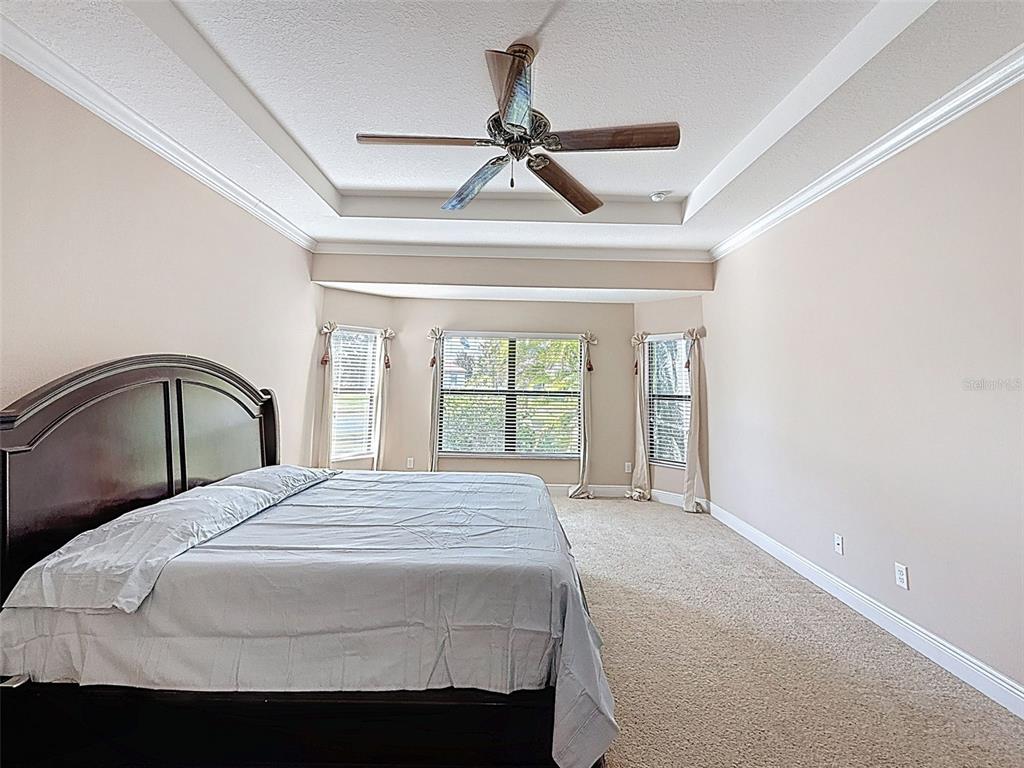335 Cockle Shell Loop Apollo Beach, FL 33572 - Photo 26 of 90 a bedroom with a bed and a large window