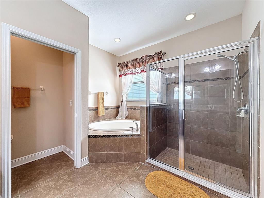 335 Cockle Shell Loop Apollo Beach, FL 33572 - Photo 31 of 90 a bathroom with a shower a toilet and a sink