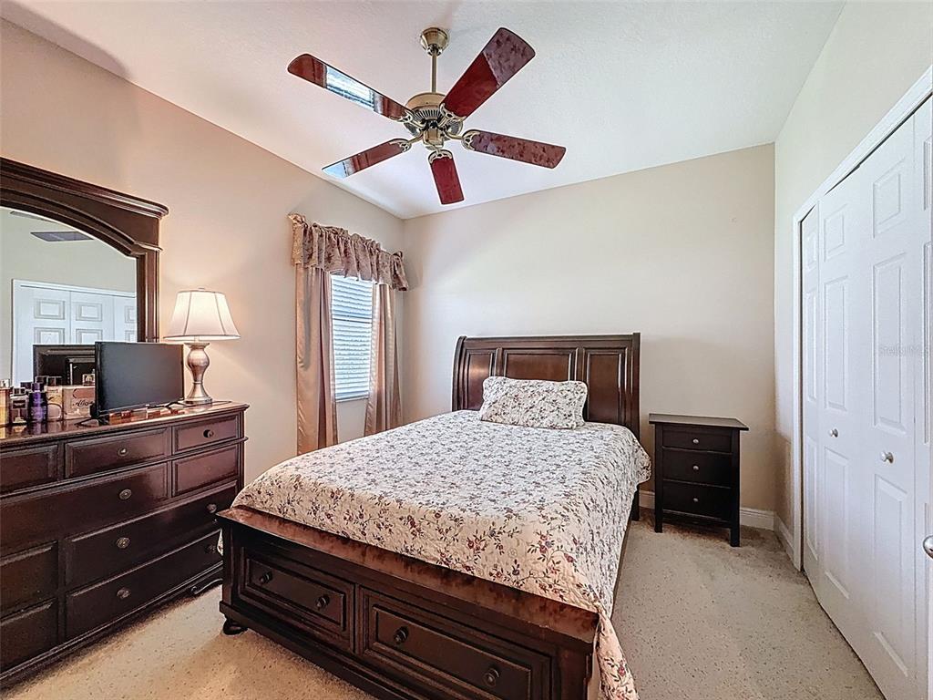 335 Cockle Shell Loop Apollo Beach, FL 33572 - Photo 35 of 90 a bedroom with a bed and a chandelier