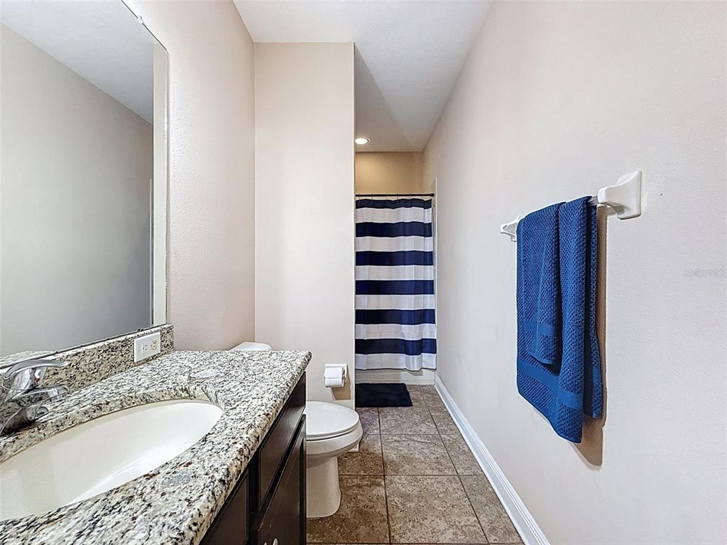 335 Cockle Shell Loop Apollo Beach, FL 33572 - Photo 39 of 90 a bathroom with a granite countertop sink and a mirror
