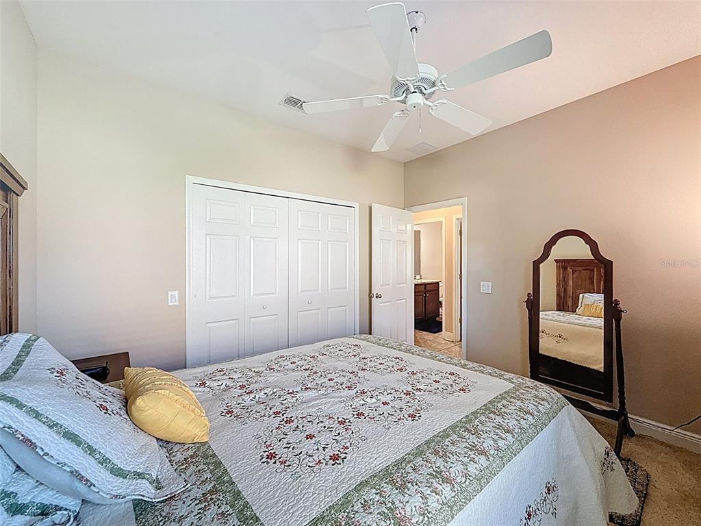 335 Cockle Shell Loop Apollo Beach, FL 33572 - Photo 45 of 90 a bedroom with a bed and a chandelier